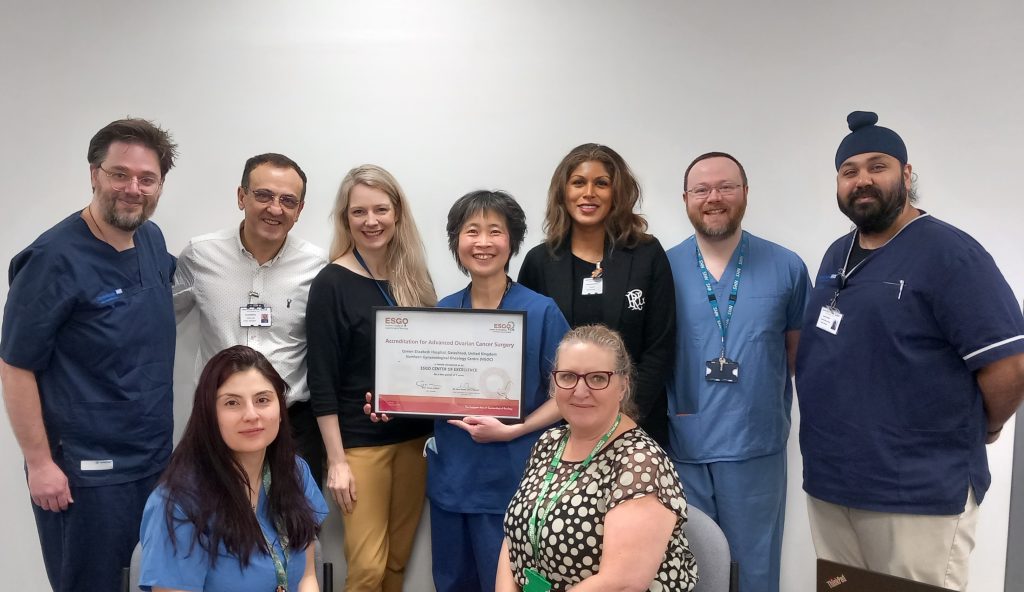 Wide angle photo of the Gynaecological Oncology team holding the accreditation certificate. 