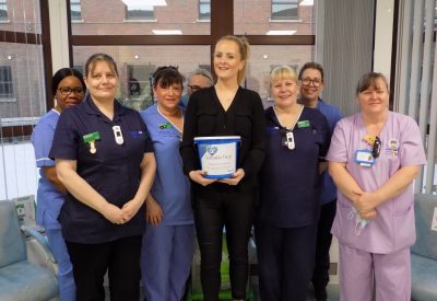 A photograph of Kathryn with the nursing team at the Tranwell unit.