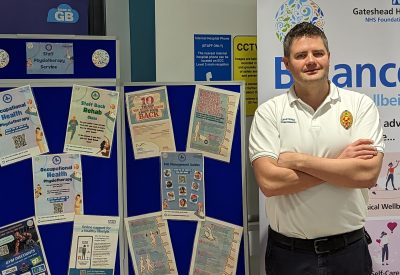 John Paul Gowland promoting new service at a stall in QE Hospital