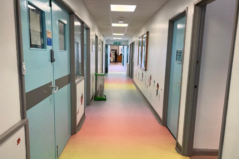 Rainbow flooring and blue doors in children's unit