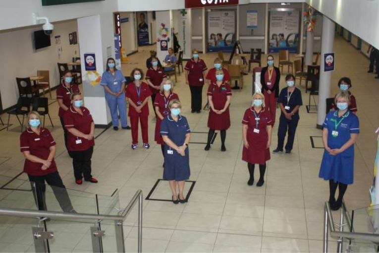 Group photo of cancer services team in foyer of Gateshead hospital