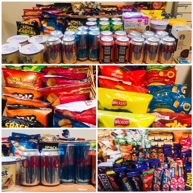 A picture of Kathryn's tuck shop at her office, including crisps, cans of pop and chocolate.