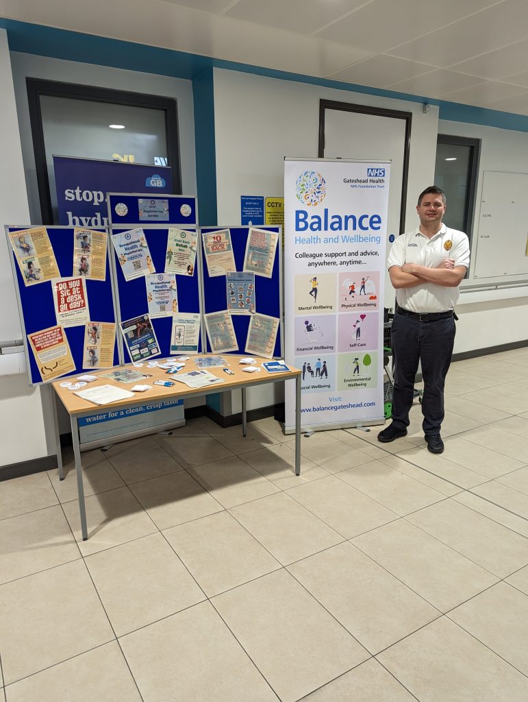 John Paul Gowland promoting new service at a stall in QE Hospital