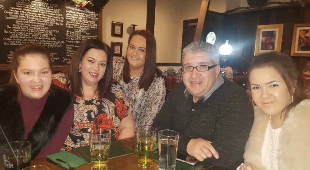 Molly's beloved mother Tricia Hughes in a restaurant with her family