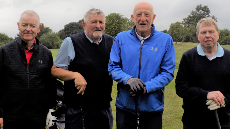 4 men with golf kit