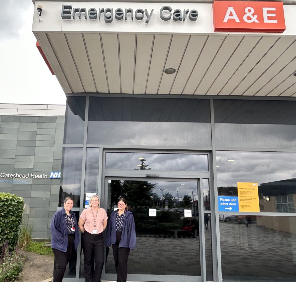 Three members of reception staff outside the accident and emergency reception