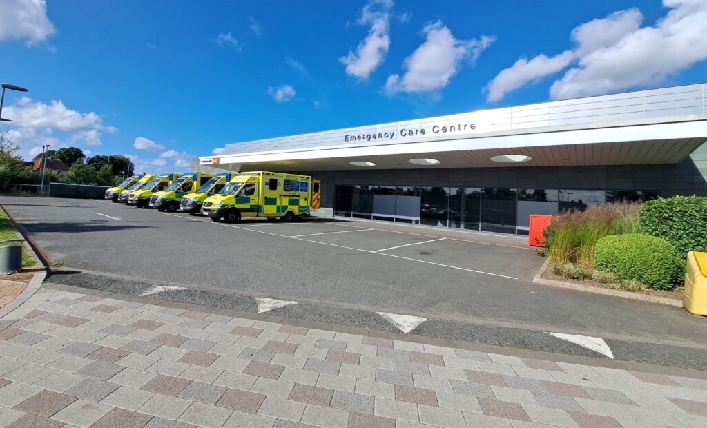 Photo outside the emergency care centre with six ambulances lined up.