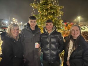 Group photo of Trudie Davies, Lewis Miley, Jamie Miley and Kris Mackenzie. in front of the tree of stars.