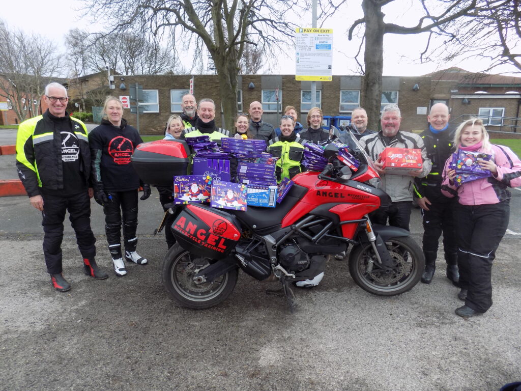 bikers stood with collection boxes