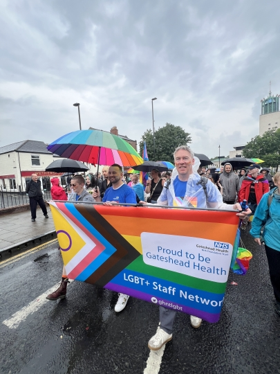 Group marching at pride