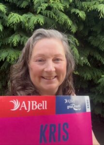 Headshot photo of Kris, one of our charity runners, holding her great north run number.
