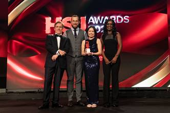 A group of four people receiving an award at the HSJ awards ceremony 
