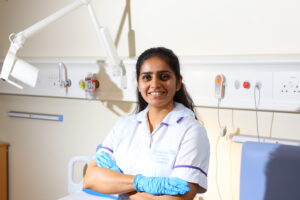 A portrait style photo of Smruthi, wearing NHS uniform