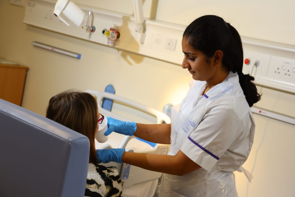 A speech and language therapist undertaking swallowing therapy with a patient. 