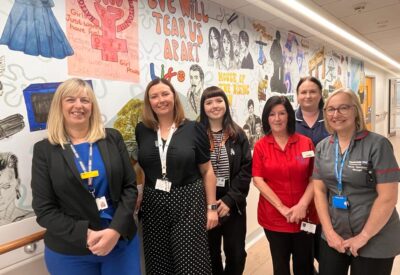 group picture in front of the mural