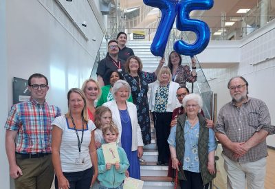 Staff with local MP, councillors and residents celebrating NHS75