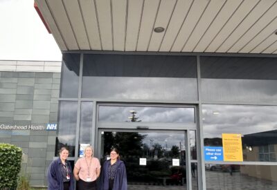 Three members of reception staff outside the accident and emergency reception