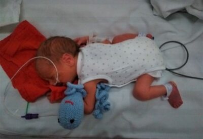 Photo of baby Jamie in his hospital cot